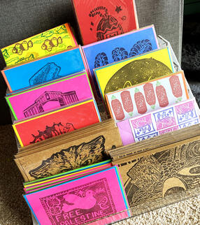 My display of hand-stamped linocut cards. Each card is an original print stamped with archival ink on colorful cards.